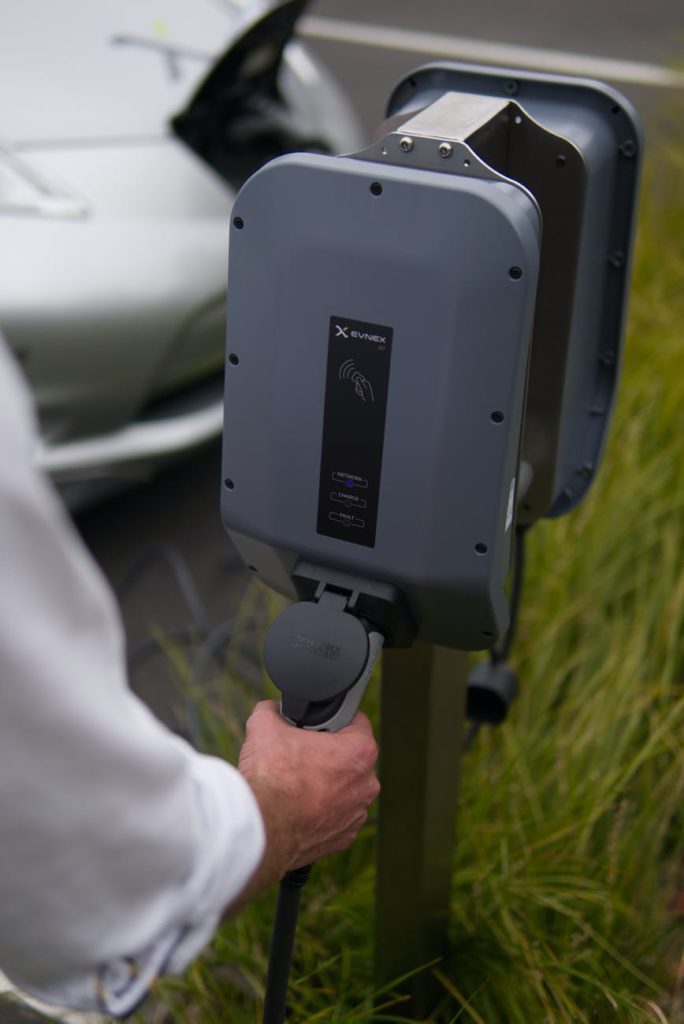 close up view of a person holding the ev charger