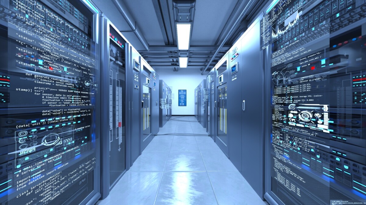 Data center corridor with rows of server racks and blue-tinged lighting, code and dashboards displayed on panels nearby.